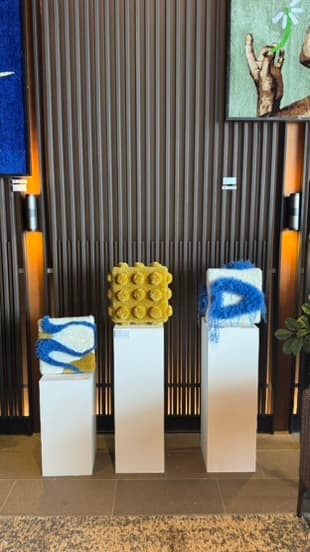Fybre Studios' tufted pieces displayed on pedestals at Korea Craft Week, Ananti Busan Cove