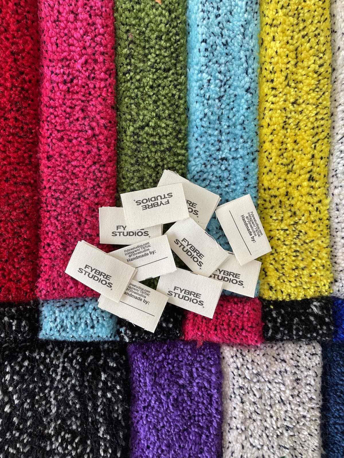 FYBR branded tags on colourful yarn swatches