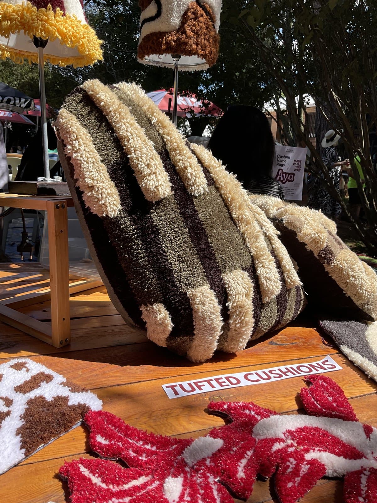 Market stall display including a hand-shaped tufted rug