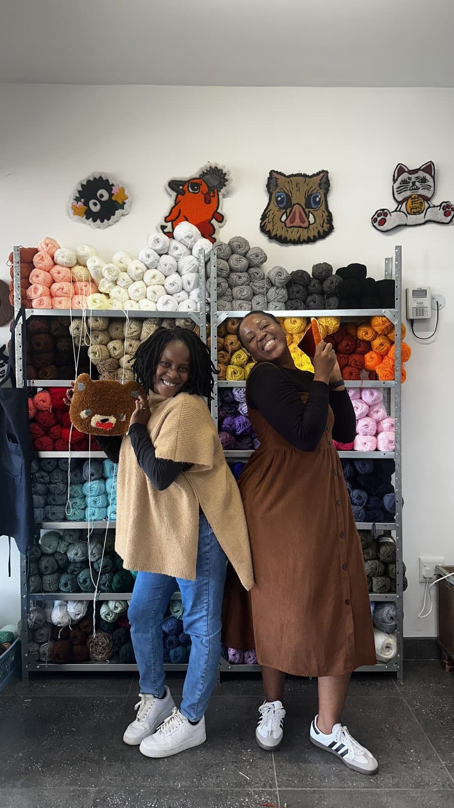 Fybre Studios shopfront display with tufted patches and rugs on shelves