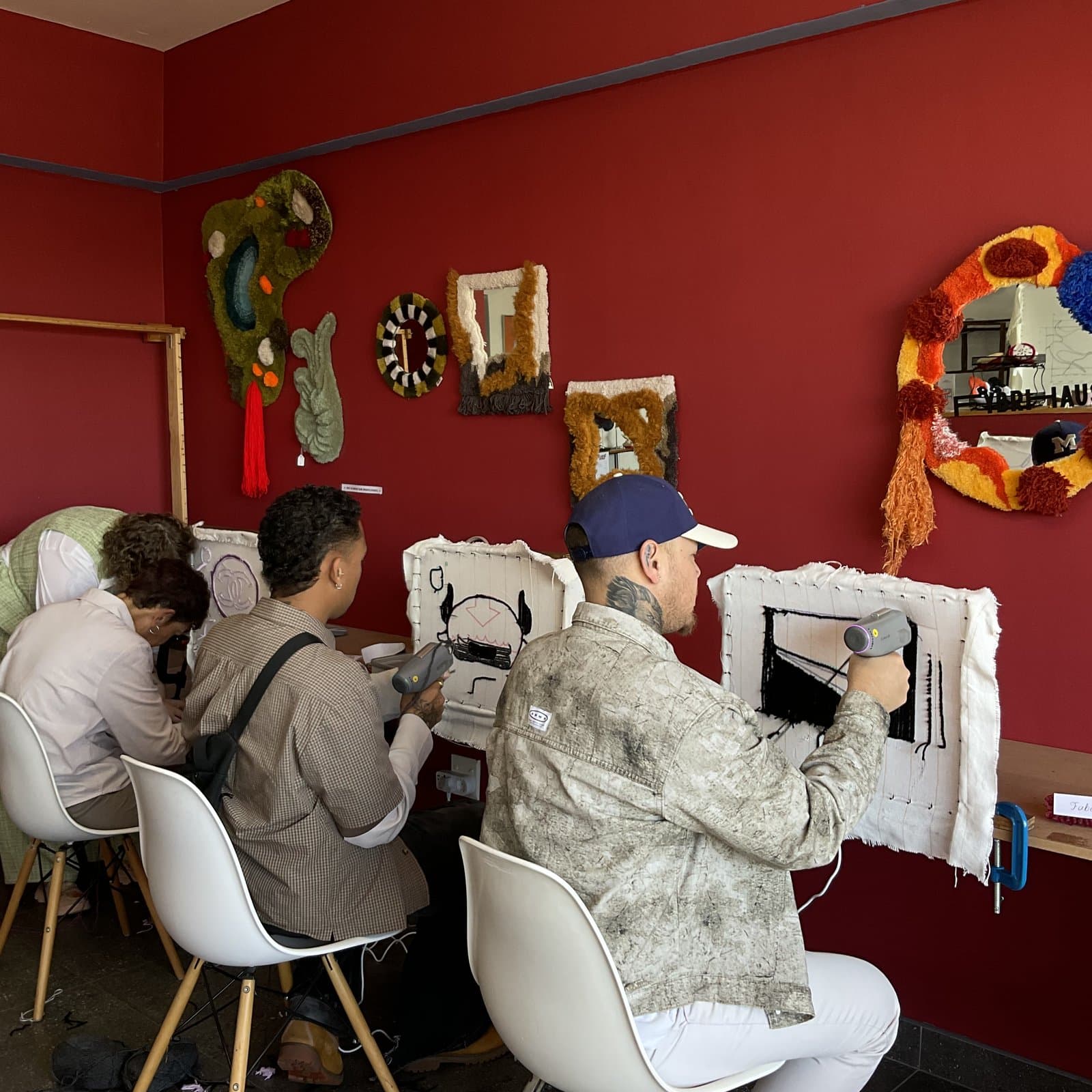 Group of students working together at tufting frames