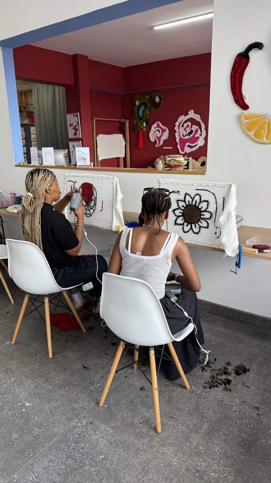 Instructor and student working at tufting frames in class