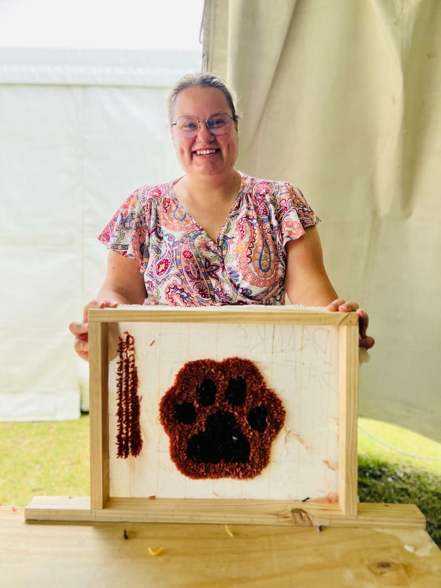Guest tufting a rug at a Fybre Studios class or market event