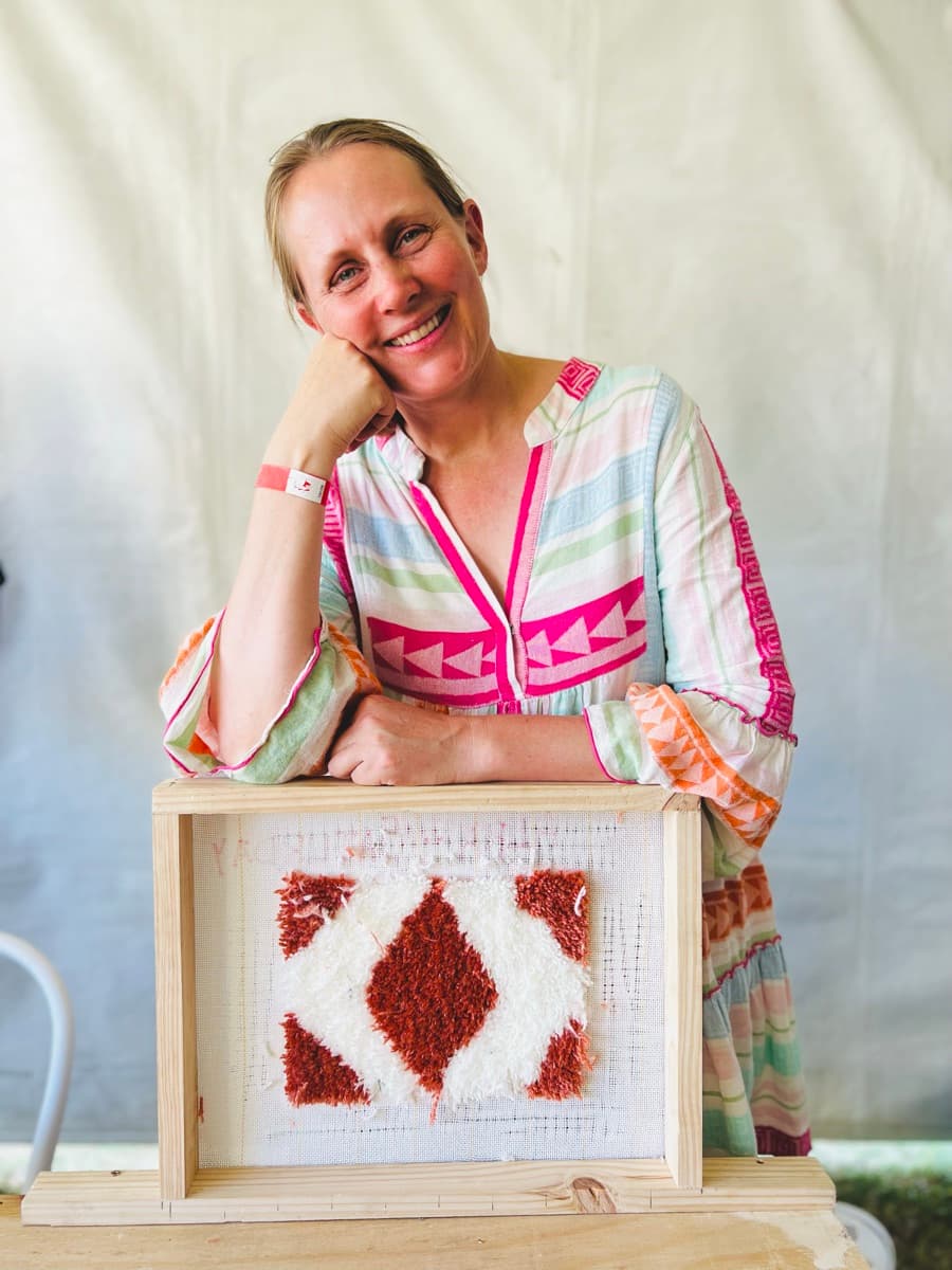 Guest tufting a rug at a Fybre Studios class or market event