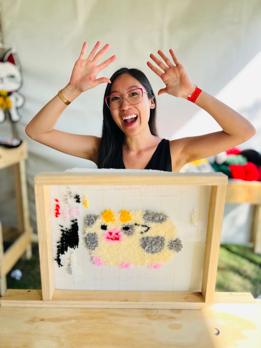 Guest tufting a rug at a Fybre Studios class or market event