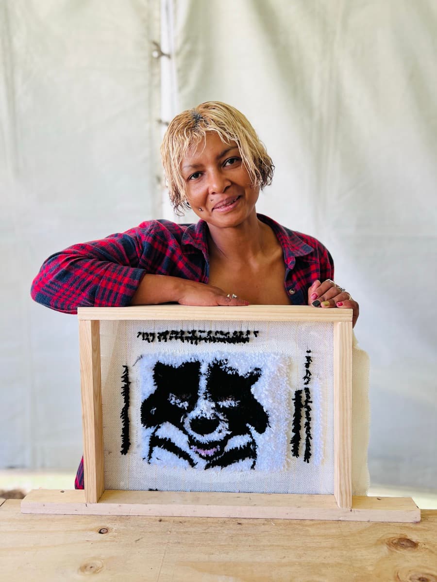 Guest tufting a rug at a Fybre Studios class or market event